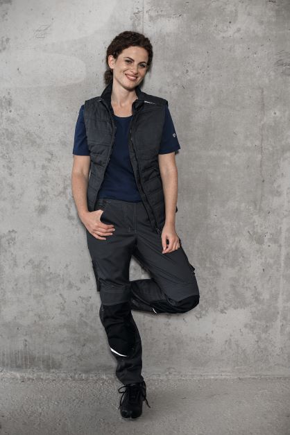 A woman wears work clothes for women in building construction.